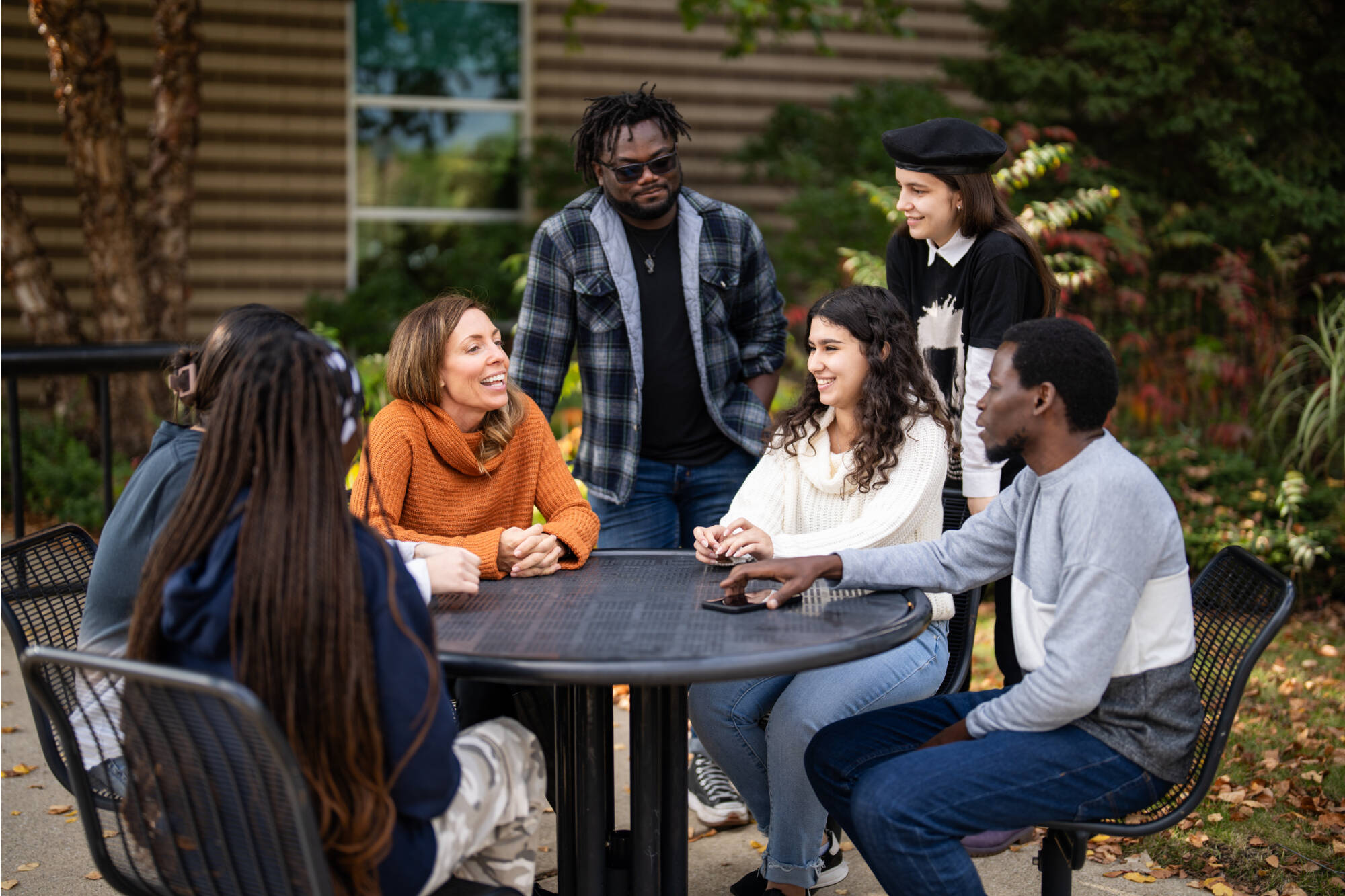 International students study and talk outside Lake Ontario Hall, where the Padnos International Center is located, October 11, 2023. (photo by Amanda Pitts)